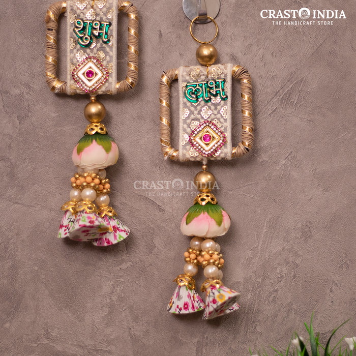 CRASTO INDIA HANDCRAFTED FESTIVE EMBROIDERED LACEWORK SHUBH LABH WITH FLORAL TASSELS.